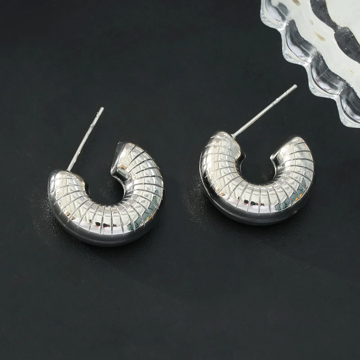 KOTOHIRA: Hollow Chunky-Look Textured Surface Tube Hoop Earrings in Silver Toned White Gold - Image 5
