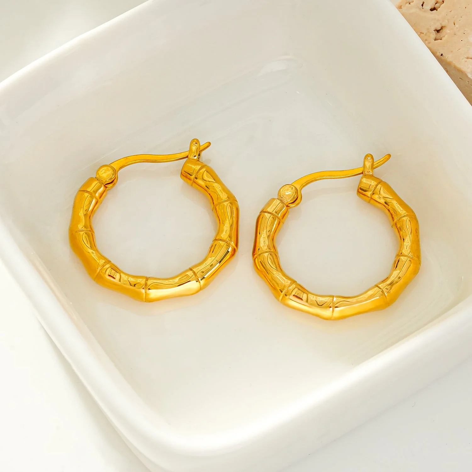 METIOS: Bamboo Textured Hoop Earrings in Gold - Image 4